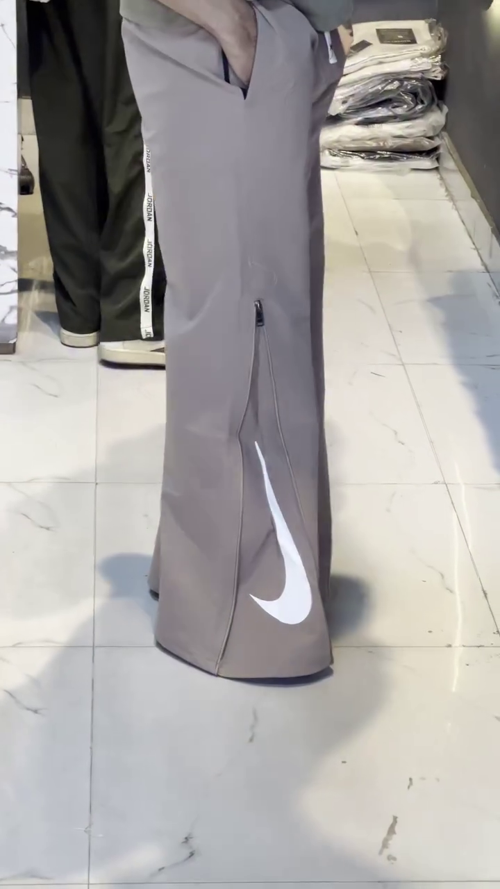Premium Taupe Athletic Wide-Leg Track Pants with Side Zip Detail and Large White Swoosh Branding 🤍